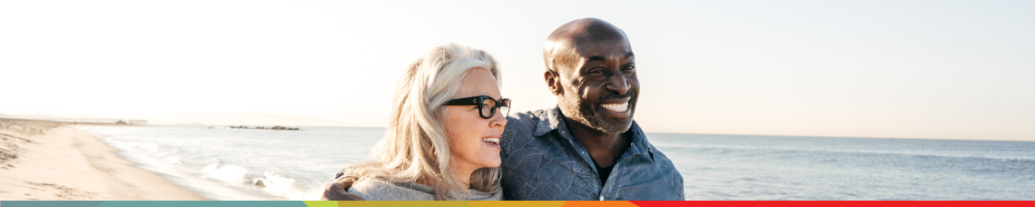 couple walking on the beach enjoying retirement