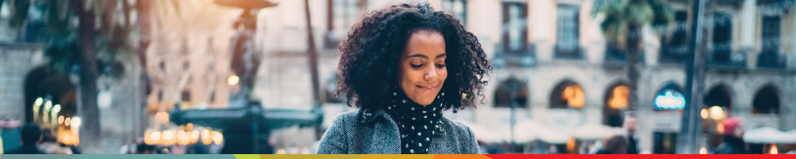 A woman smiling at her savings strategy laid out on her phone